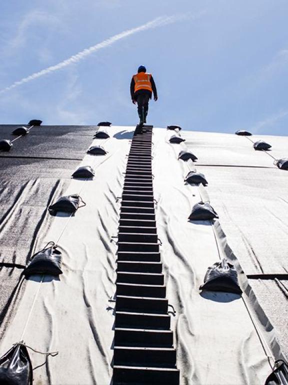 A man walking on a metallic structure